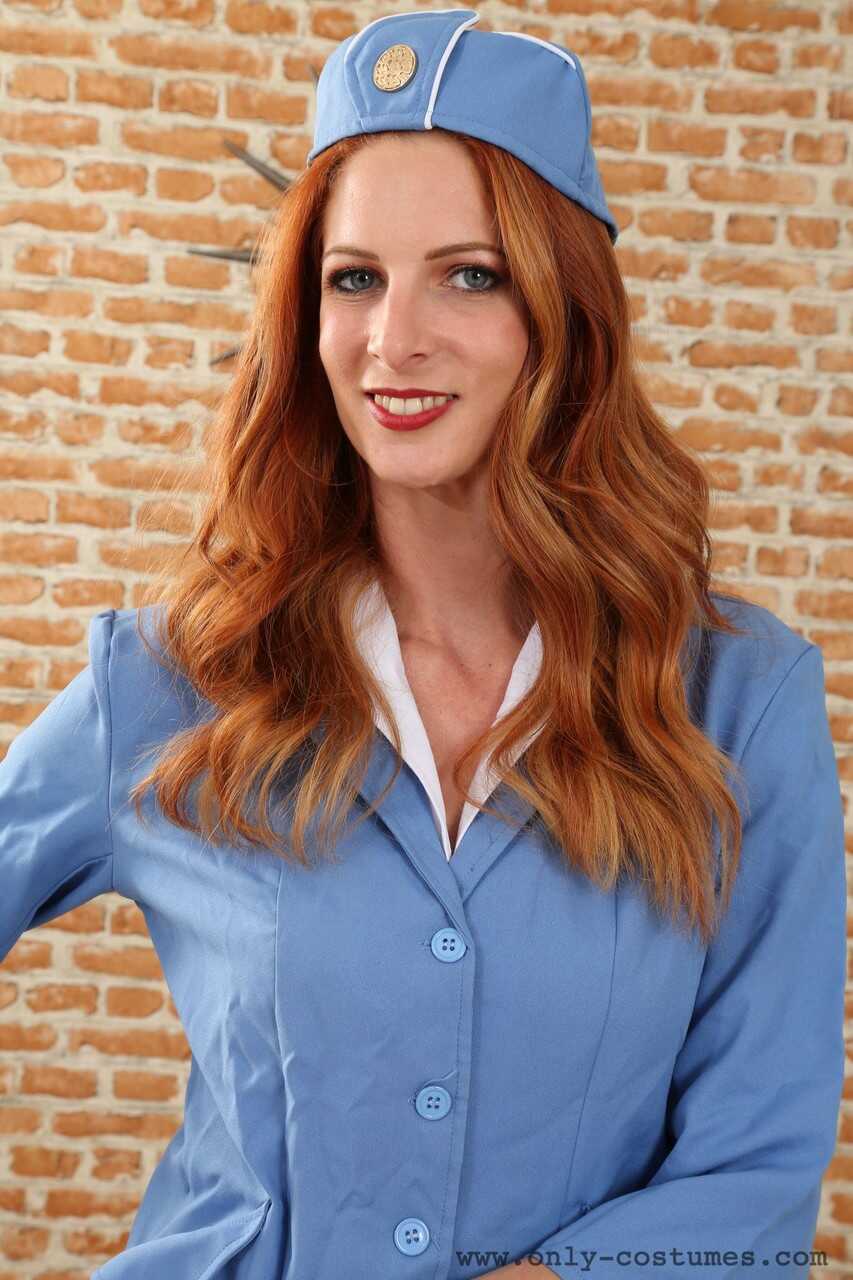 Sexy Redhead MILF Rebecca Leah strips down to her lingerie while cosplaying as a stewardess - Rebecca Leah