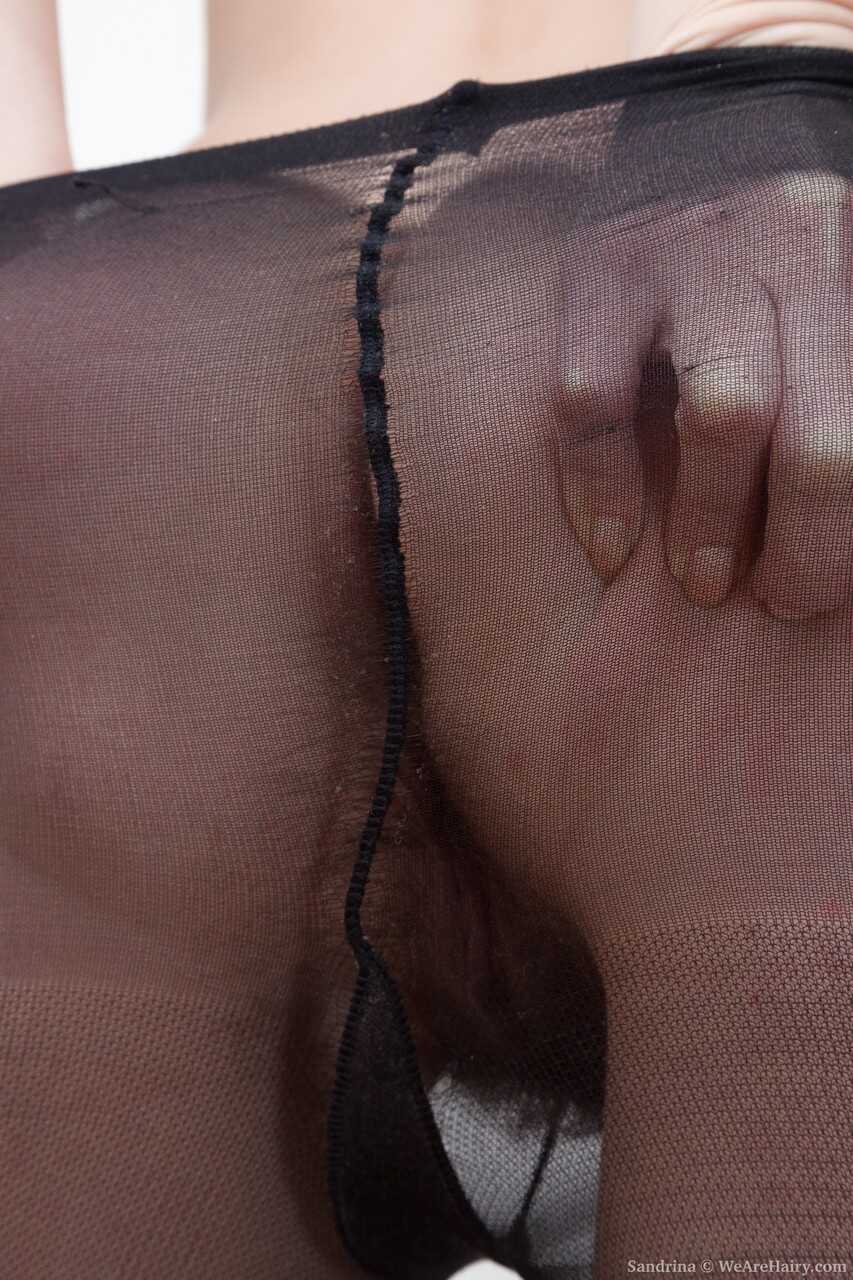 Hot cougar Sandrina strips off her black pantyhose before rubbing her fuzzy beaver as she moans in pleasure while spreadin...