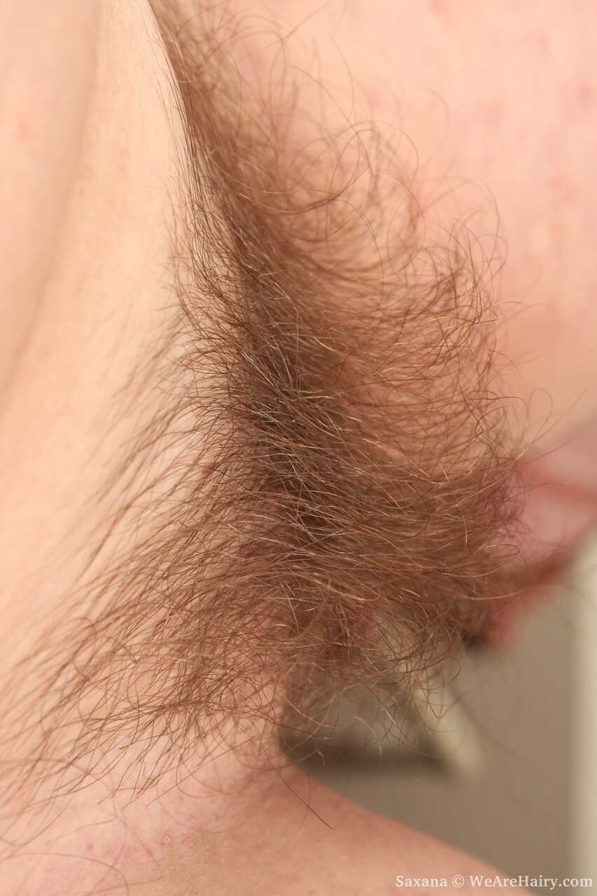 Buxom MILF with natural tits Saxana showing her hairy pussy in the kitchen while undressing, revealing her big ass and chu...