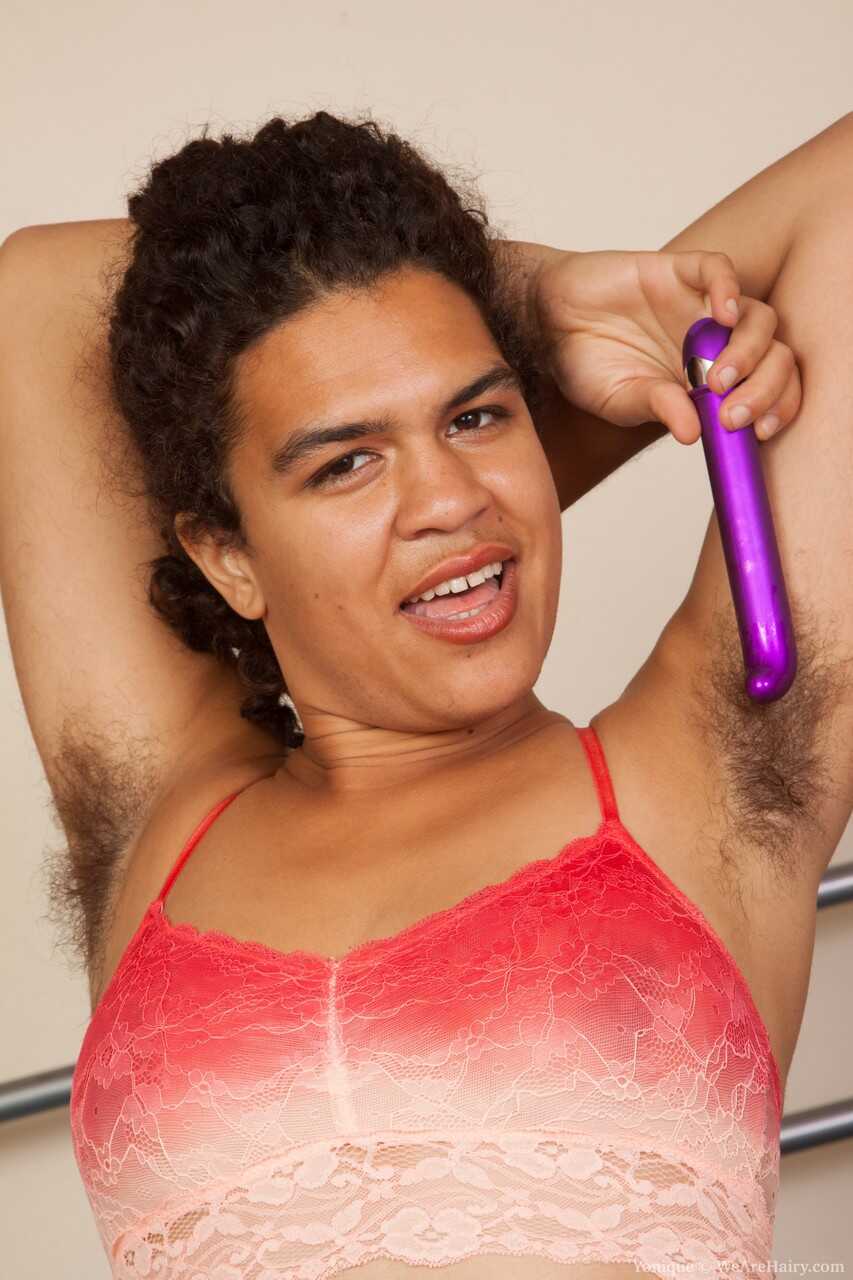 Exotic brunette with hairy body Yonique plays with purple toy on her bed gets down and dirty with her giant hairy pussy!