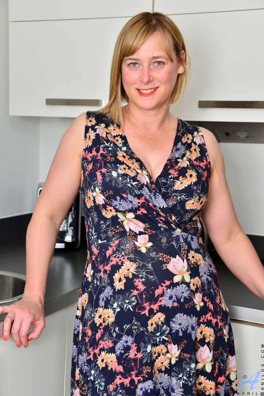Curvaceous mature April gets naked and plays with her hairy pink snatch in the kitchen while dirty talking on the phone. -...