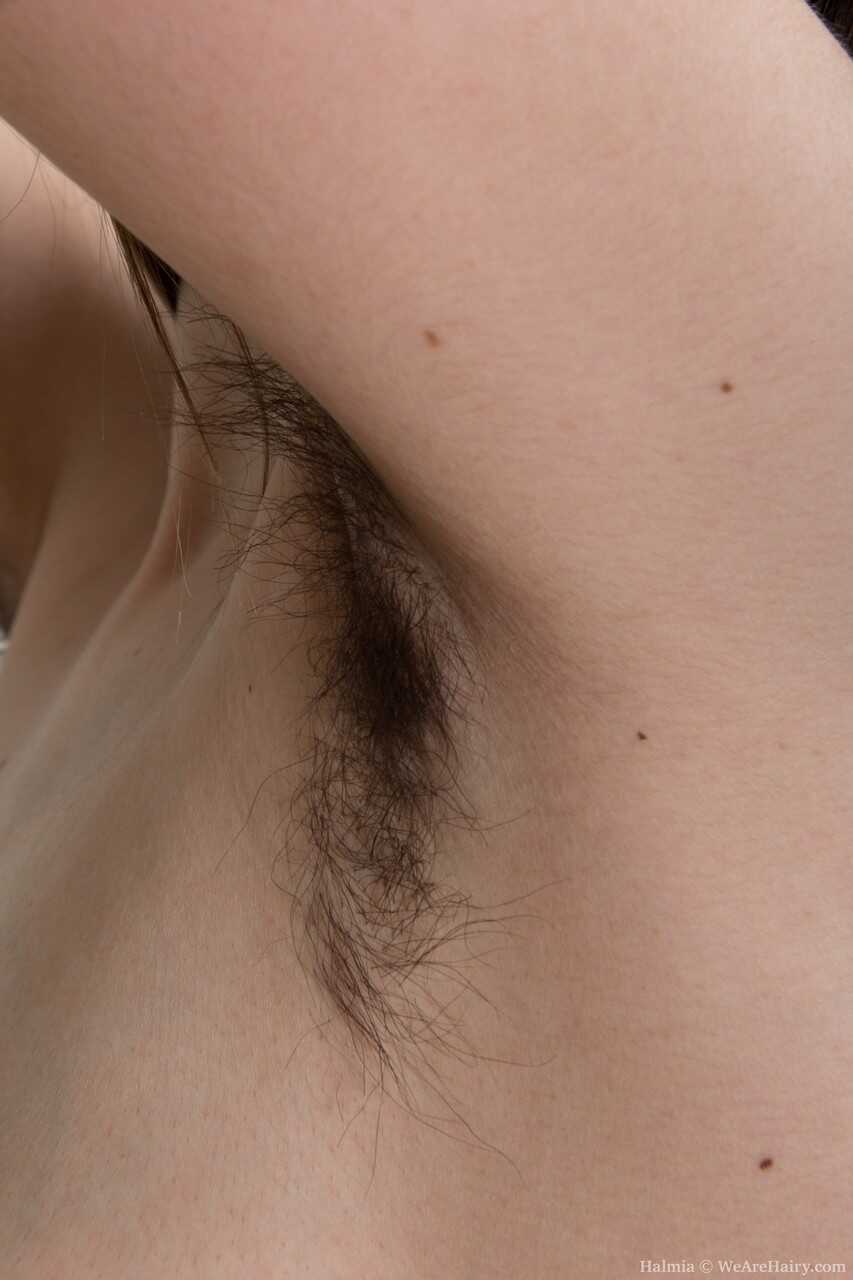 Adorable teen with big nipples Halmia displays her hairy armpits and pussy