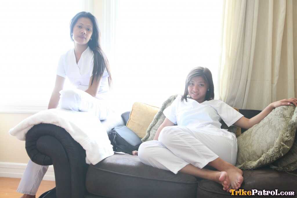 Lusty Filipina Nurses Joanna and Joy Pose on the Bed in Their White Uniforms As The Asian Beauties Explore Each Other&#039...