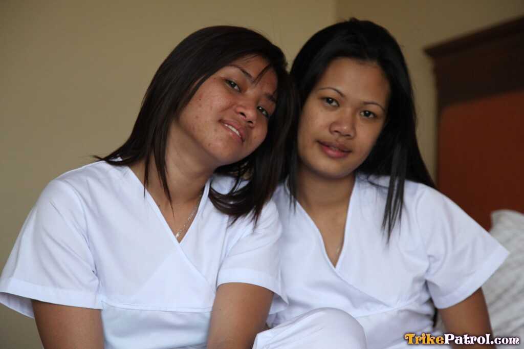 Lusty Filipina Nurses Joanna and Joy Pose on the Bed in Their White Uniforms As The Asian Beauties Explore Each Other&#039...