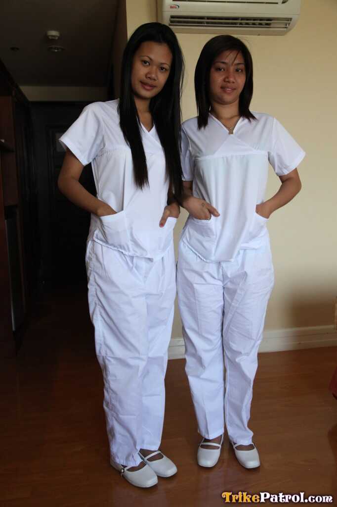 Lusty Filipina Nurses Joanna and Joy Pose on the Bed in Their White Uniforms As The Asian Beauties Explore Each Other&#039...
