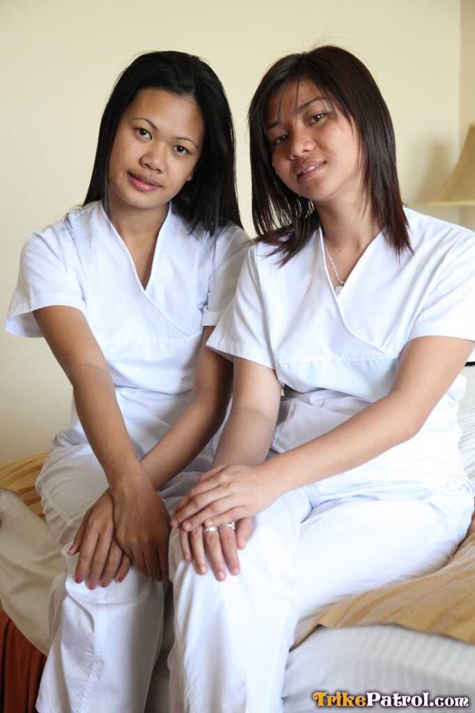 Lusty Filipina Nurses Joanna and Joy Pose on the Bed in Their White Uniforms As The Asian Beauties Explore Each Other's Bodies