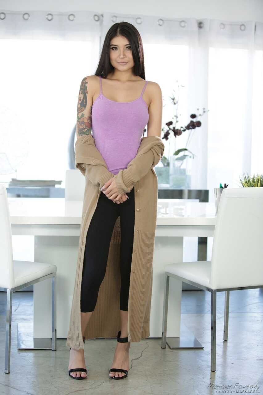 Dark haired beauty Brenna Sparks strips down for a sexy nude pose while showing off her busty Asian tits and tight legging...