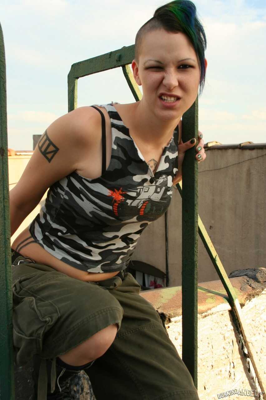 Green-haired army girl strips down and exposes her pierced nipples and trimmed bush - Chapel Waste