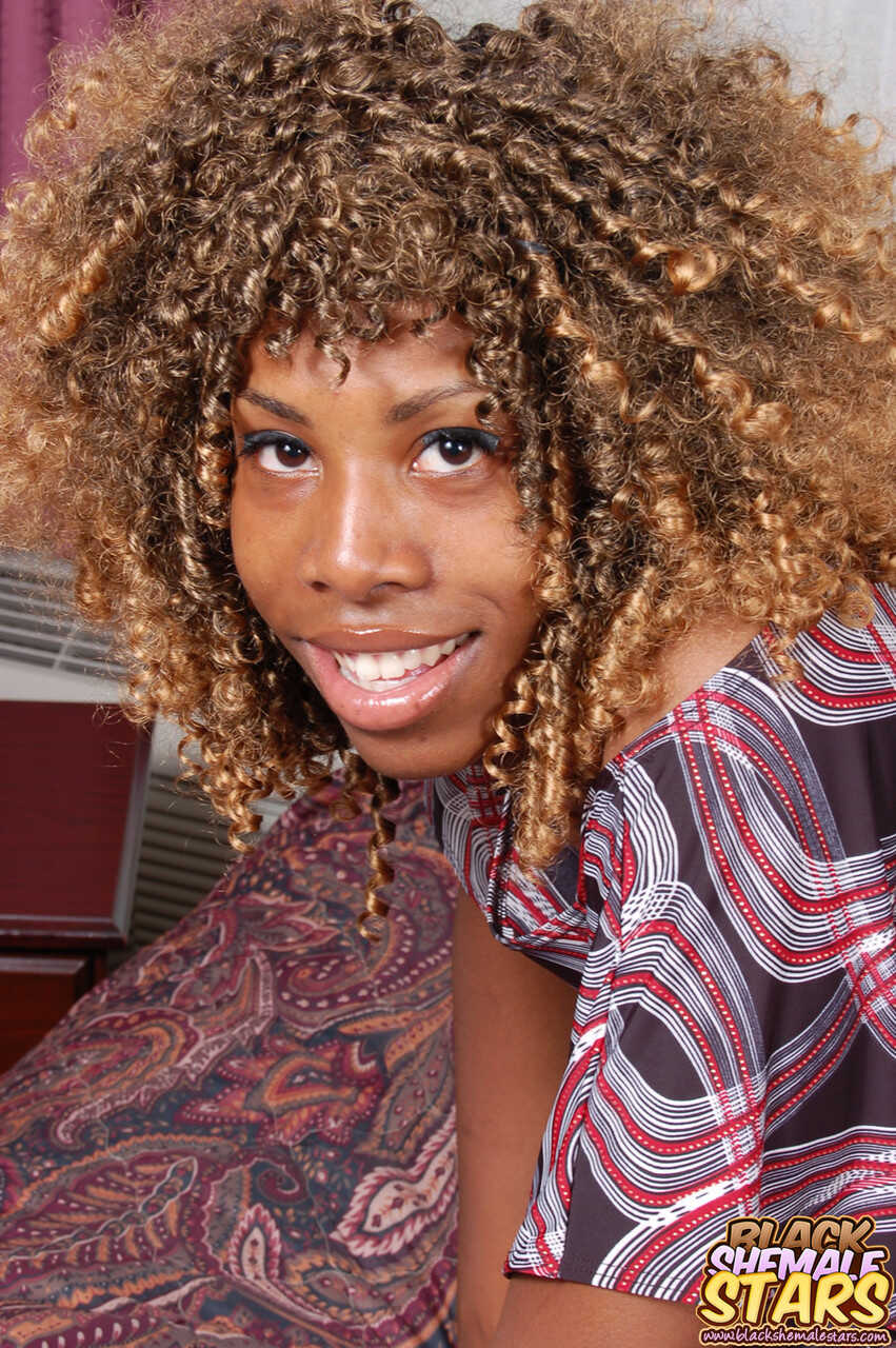 Lusty curly-haired ebony shemale Kareema fucks herself with a banana, sucking and slurping on it like her life depends on ...
