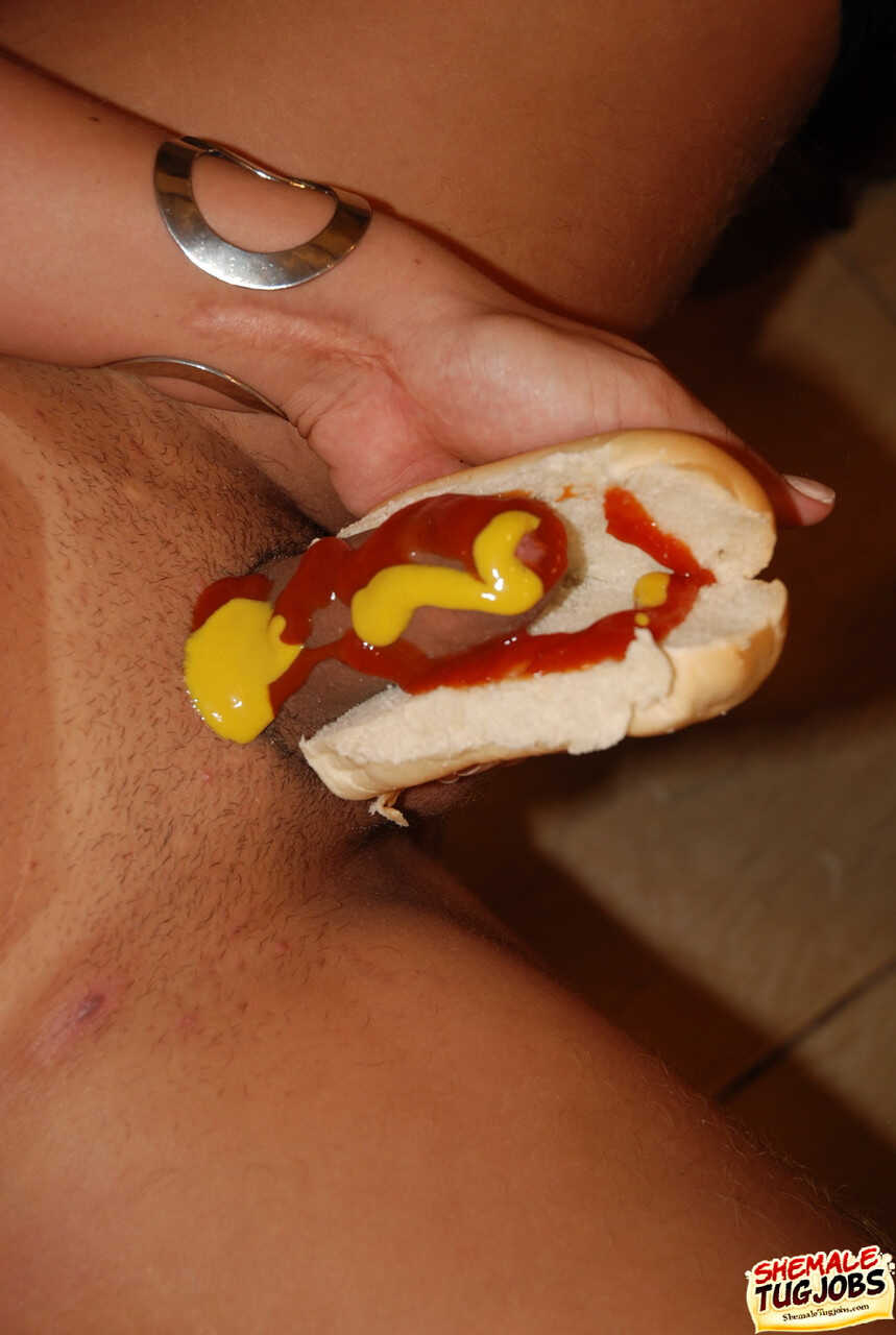 Shemale Thayssa Tally sinks her dick into a hot dog bun while showing off her big tits and tiny dick - Thayssa Tally