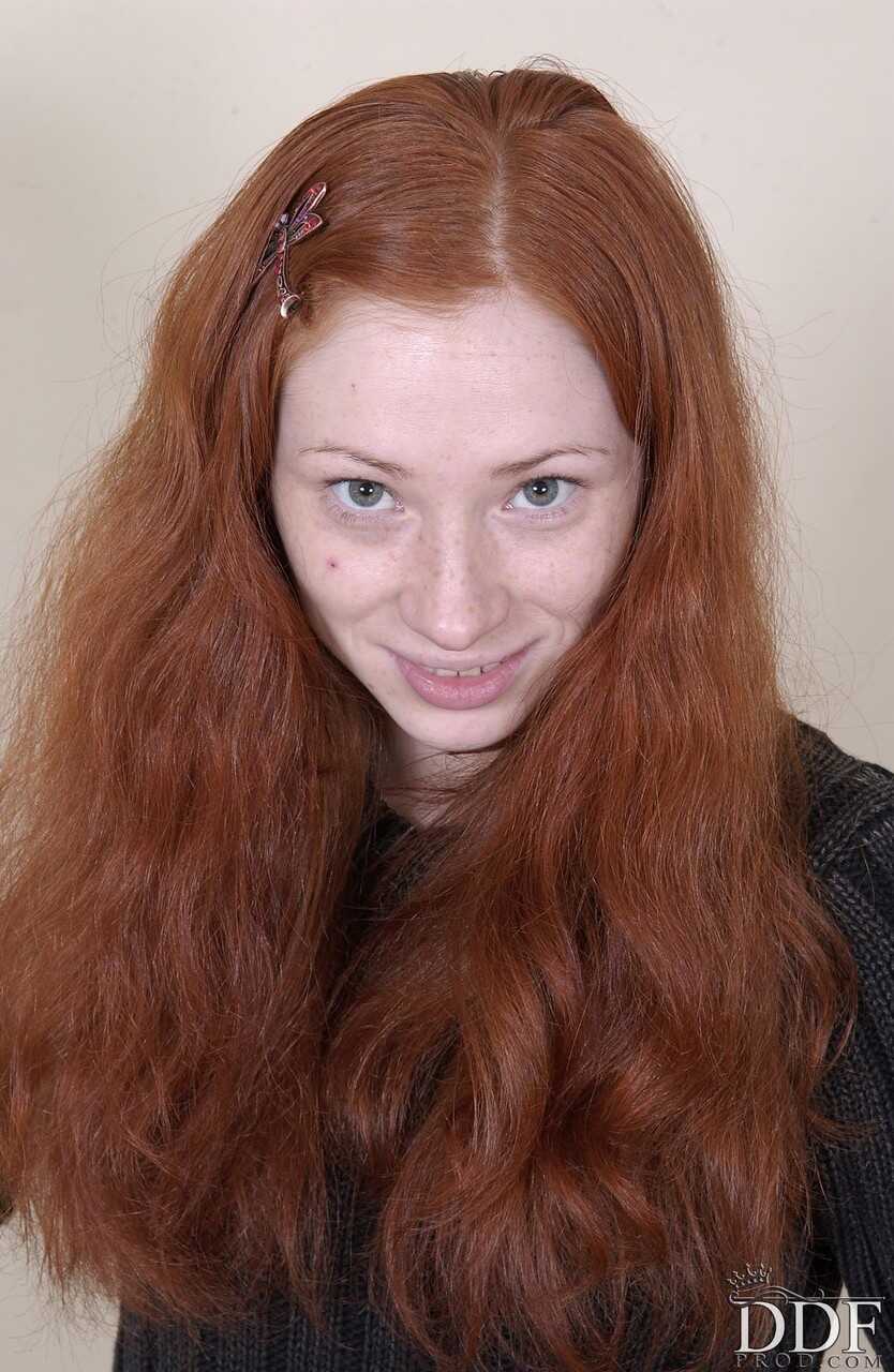 Redheaded American babe Millena exposes her slim body and presents her cunt for your viewing pleasure - Millena