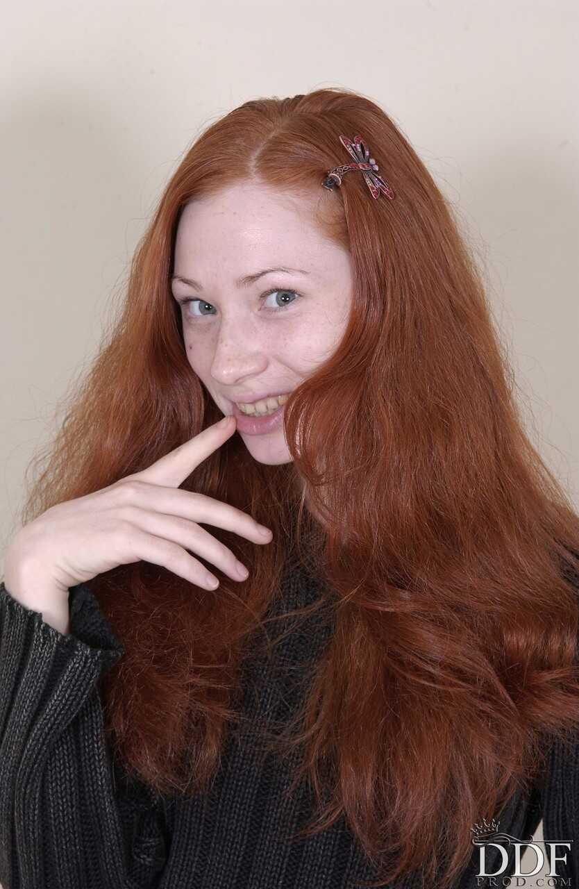 Redheaded American babe Millena exposes her slim body and presents her cunt for your viewing pleasure - Millena