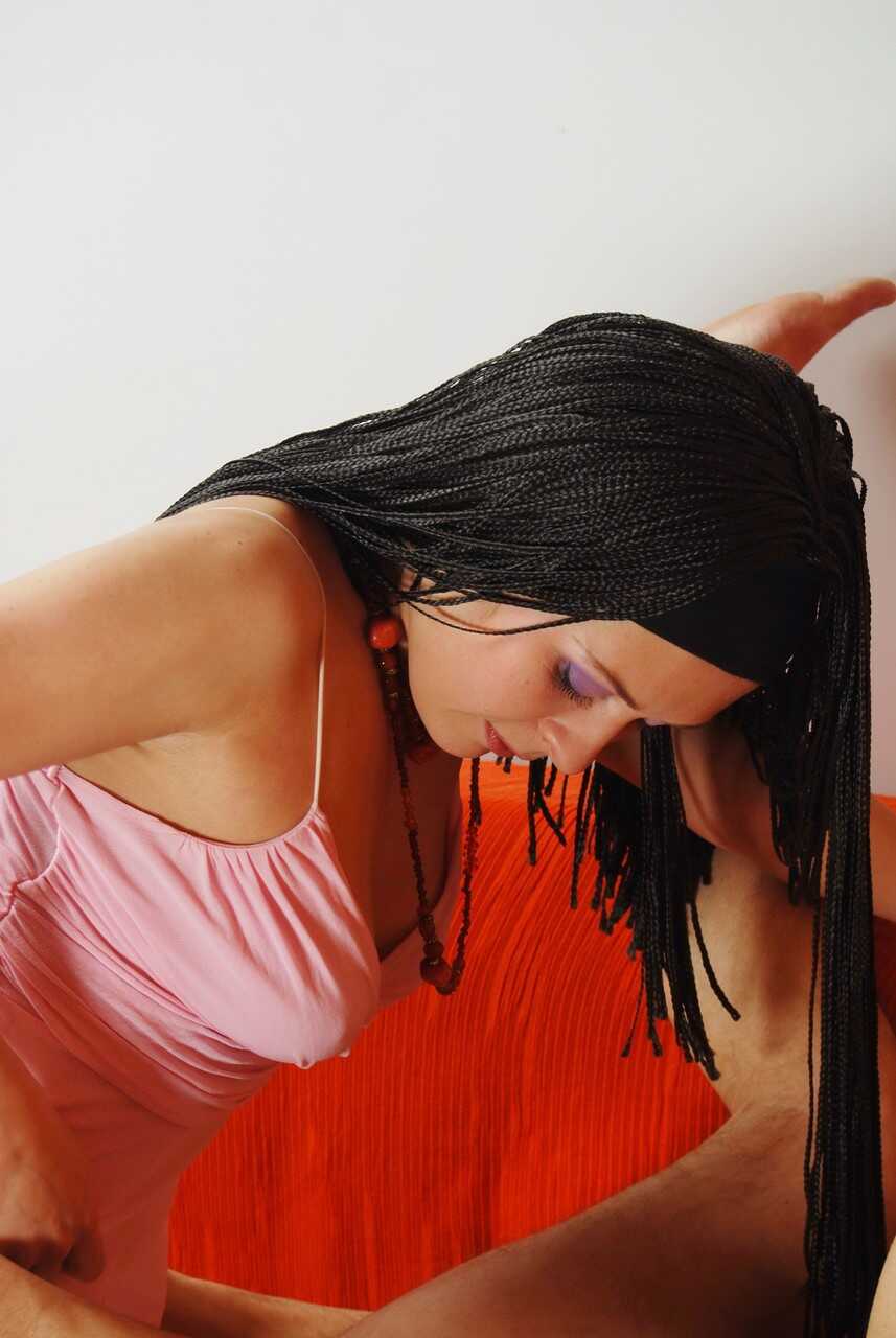 Dark haired female Oksana pegs her hairy male sub's ass with her strap-on as he cries out in pleasure on the Chesterf...