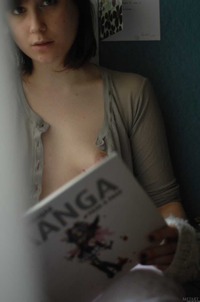 Thin and hairy Estelle K reads Manga in her natural skin while fingerless gloves slip off . - Estelle K