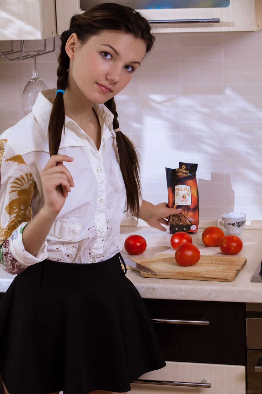 Pretty teen Iva gets naked in the kitchen and displays her hairy furry crotch. - Iva