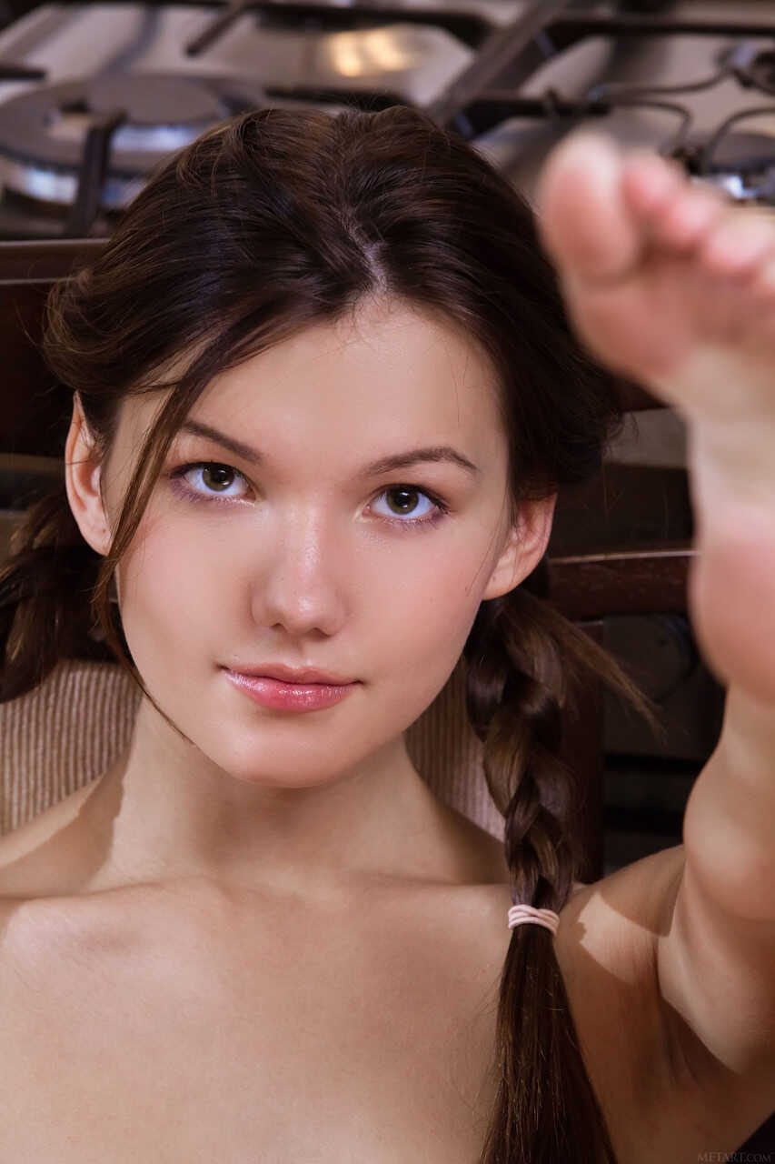Pretty teen Iva gets naked in the kitchen and displays her hairy furry crotch. - Iva