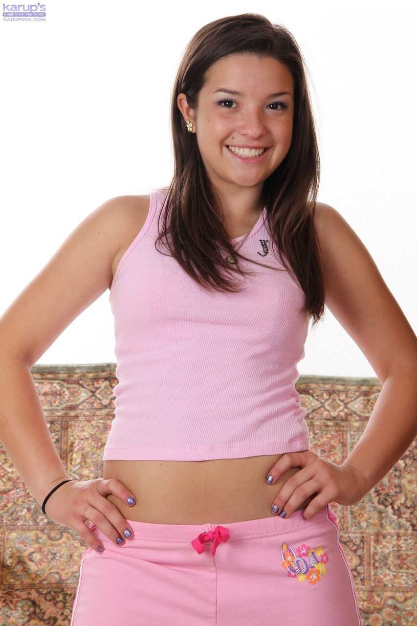 Petite Veronica in a Pink Outfit Tugs on Her Bald Vagina with a Toy While Soloing - Veronica Berry