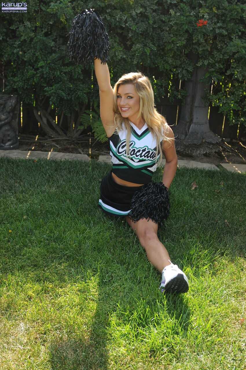 Blonde cheerleader Embry Prada shows off her toned body in the back yard