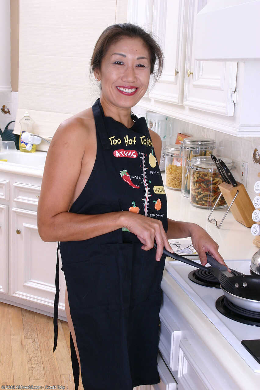 Charming Asian housewife Nina loses her apron and shows off her wet twat & big ass for the camera - Nina