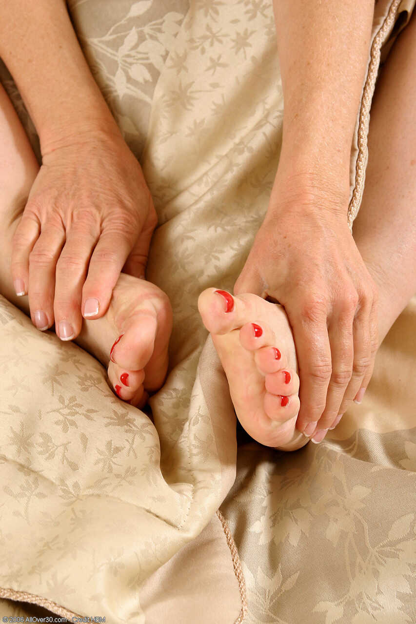 Petite mature woman Robin Pachino touches and licks her sexy painted toes while showing off her hot MILF feet! - Robin Pac...