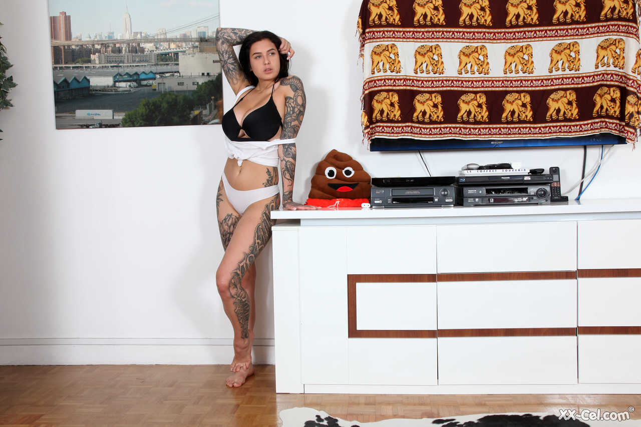 Heavily tattooed brunette Evgenia Talanina flaunting her big tanned tits for the camera - Evgenia Talanina