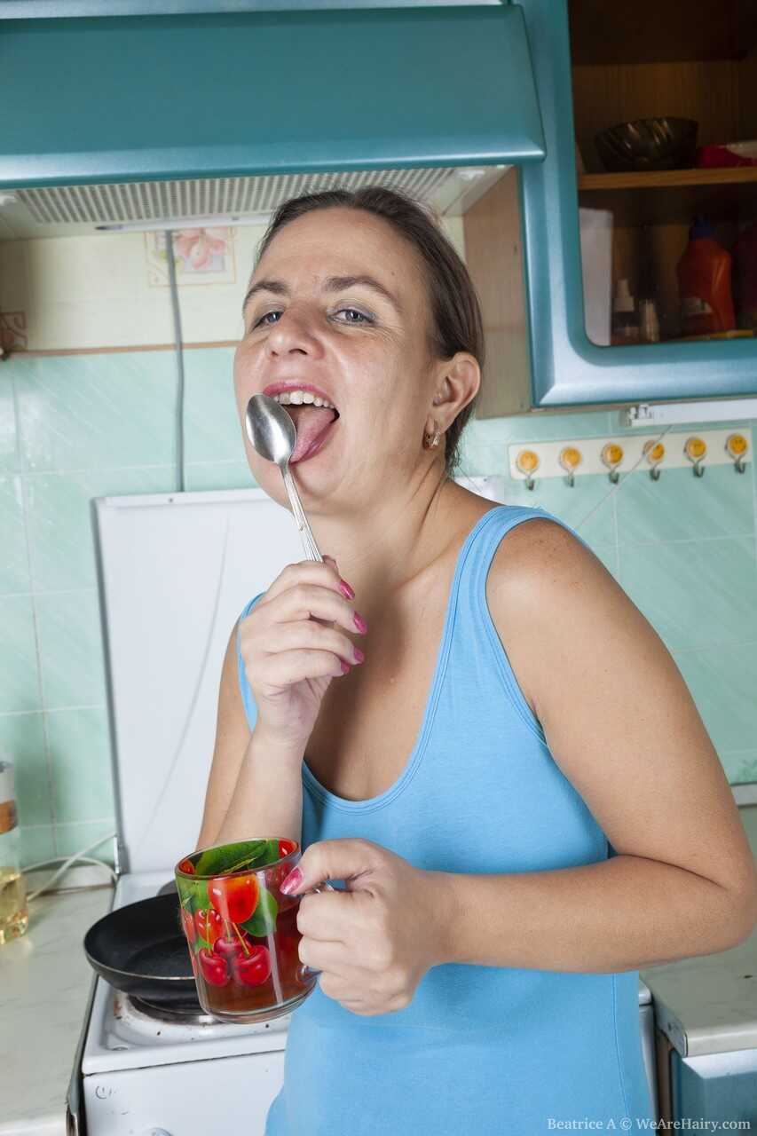 Cute mature housewife Beatrice A plays with her furry pussy in the kitchen while she cooks up some hot sex! - Beatrice A