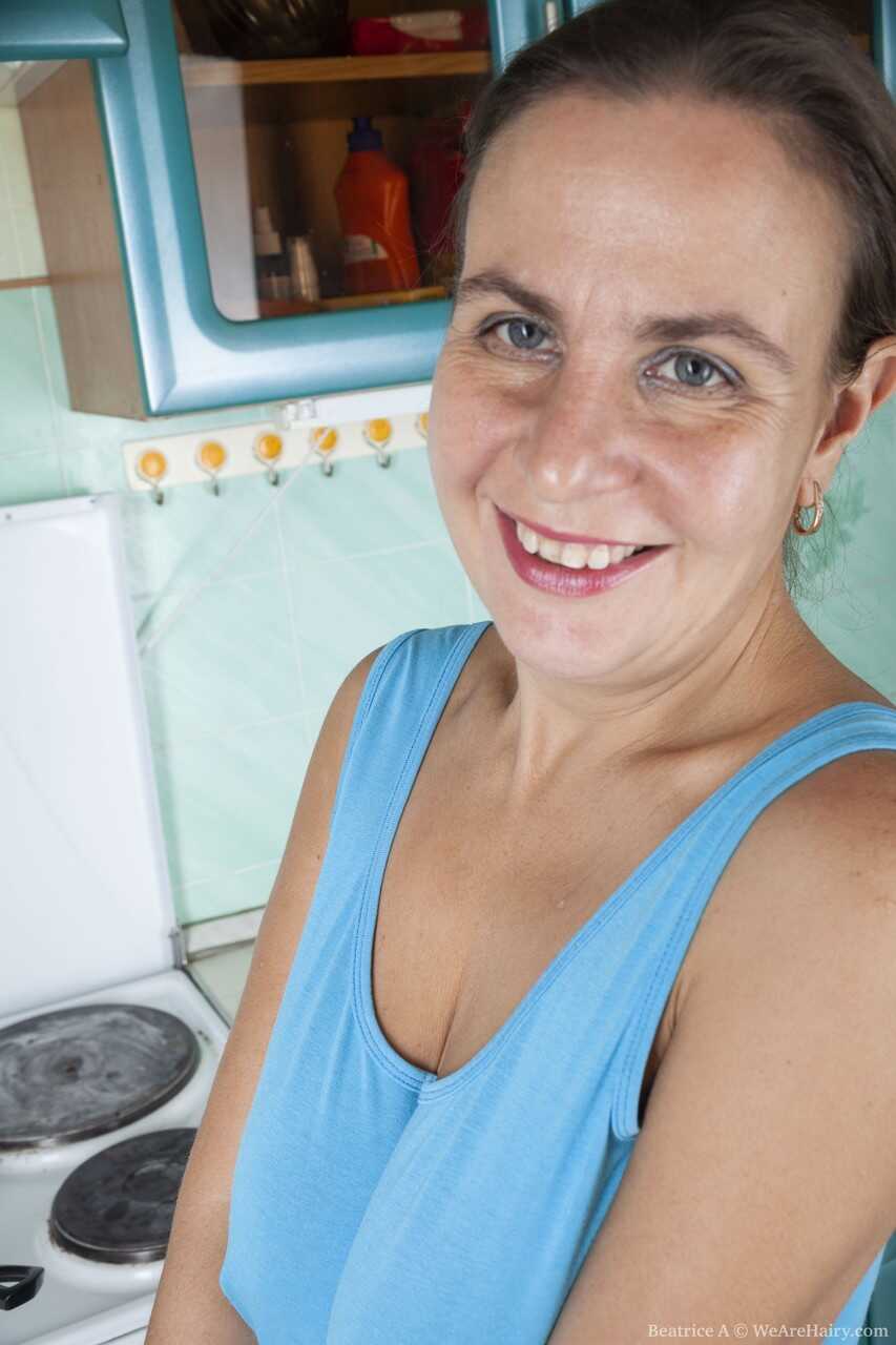 Cute mature housewife Beatrice A plays with her furry pussy in the kitchen while she cooks up some hot sex! - Beatrice A