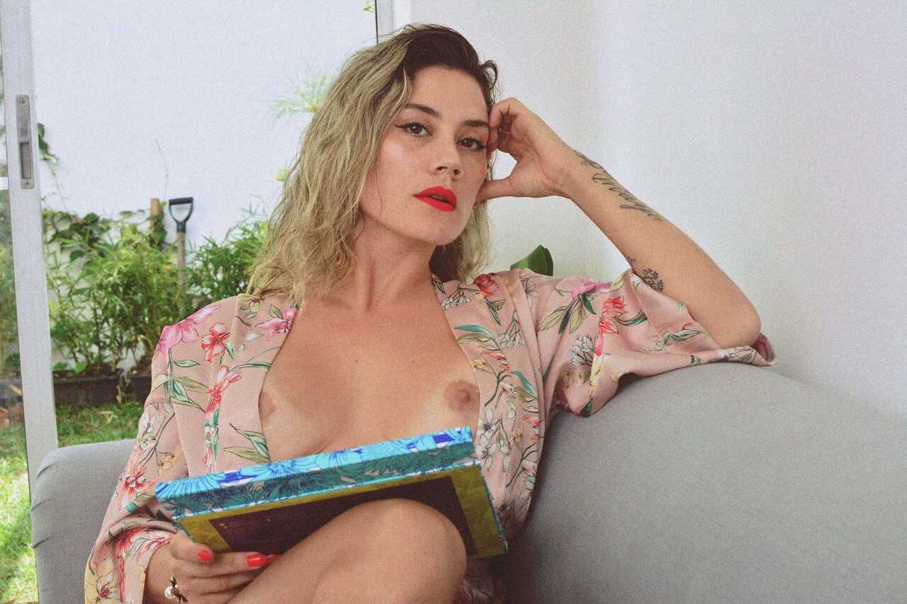 Inked MILF Andrea Garcia's Curly Blonde MILF Selfie Reveals Her Amazing Big Tits and Tan Lines While Reading on a Cou...