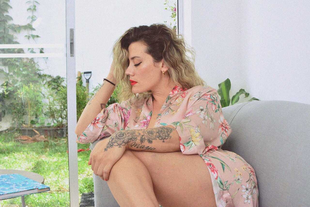 Inked MILF Andrea Garcia's Curly Blonde MILF Selfie Reveals Her Amazing Big Tits and Tan Lines While Reading on a Cou...