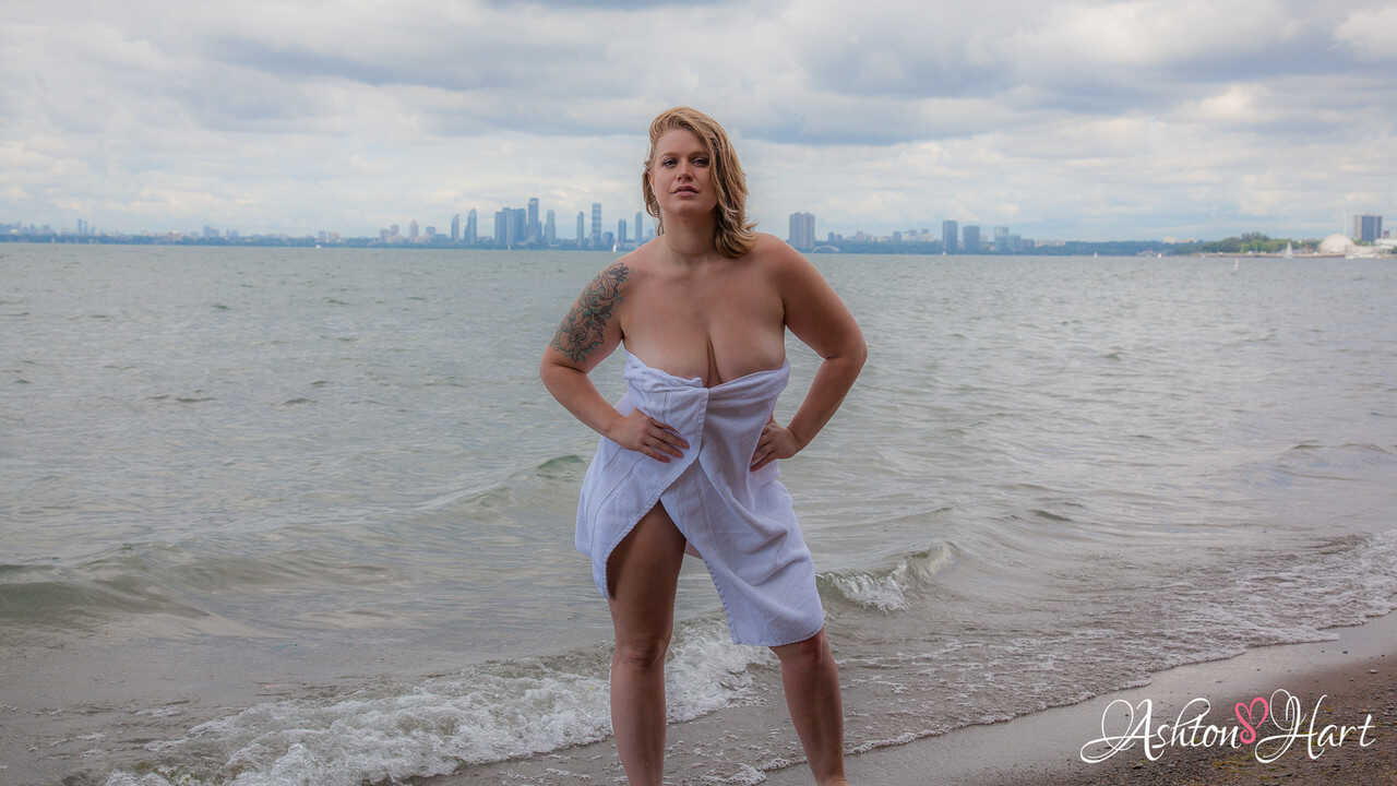 Blonde fatty with big saggy tits Ashton Hart poses nude on the beach, exposing her thick milf pussy and chubby big tits to...