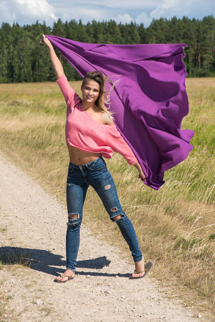 Blonde Kiana Poses on the Deserted Road in Her Skimpy Jeans and Tight Sneakers