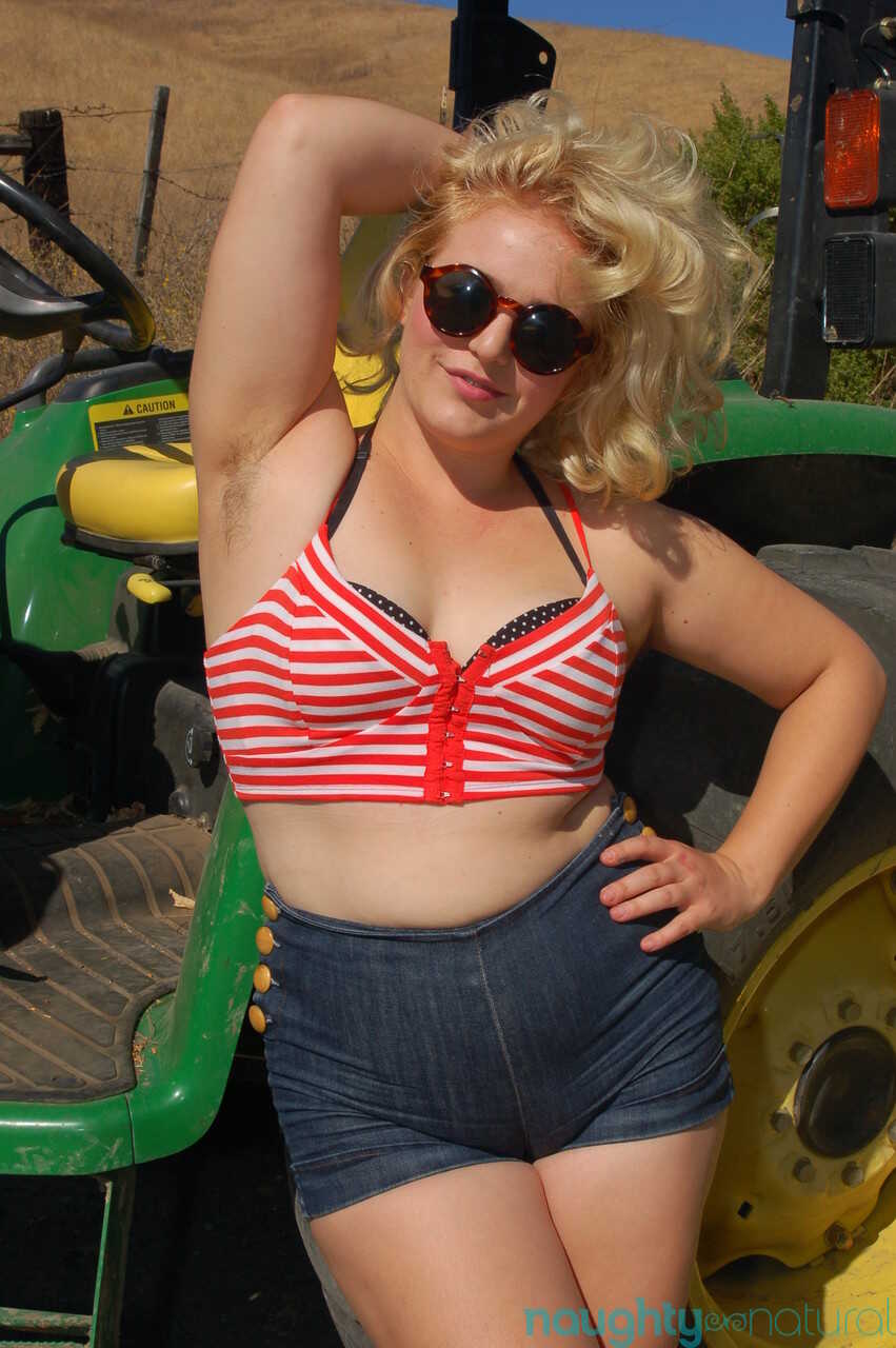 Chubby blonde Poppy Cox strips on a tractor & shows her curves & hairy twat while armpit wiping - Poppy Cox