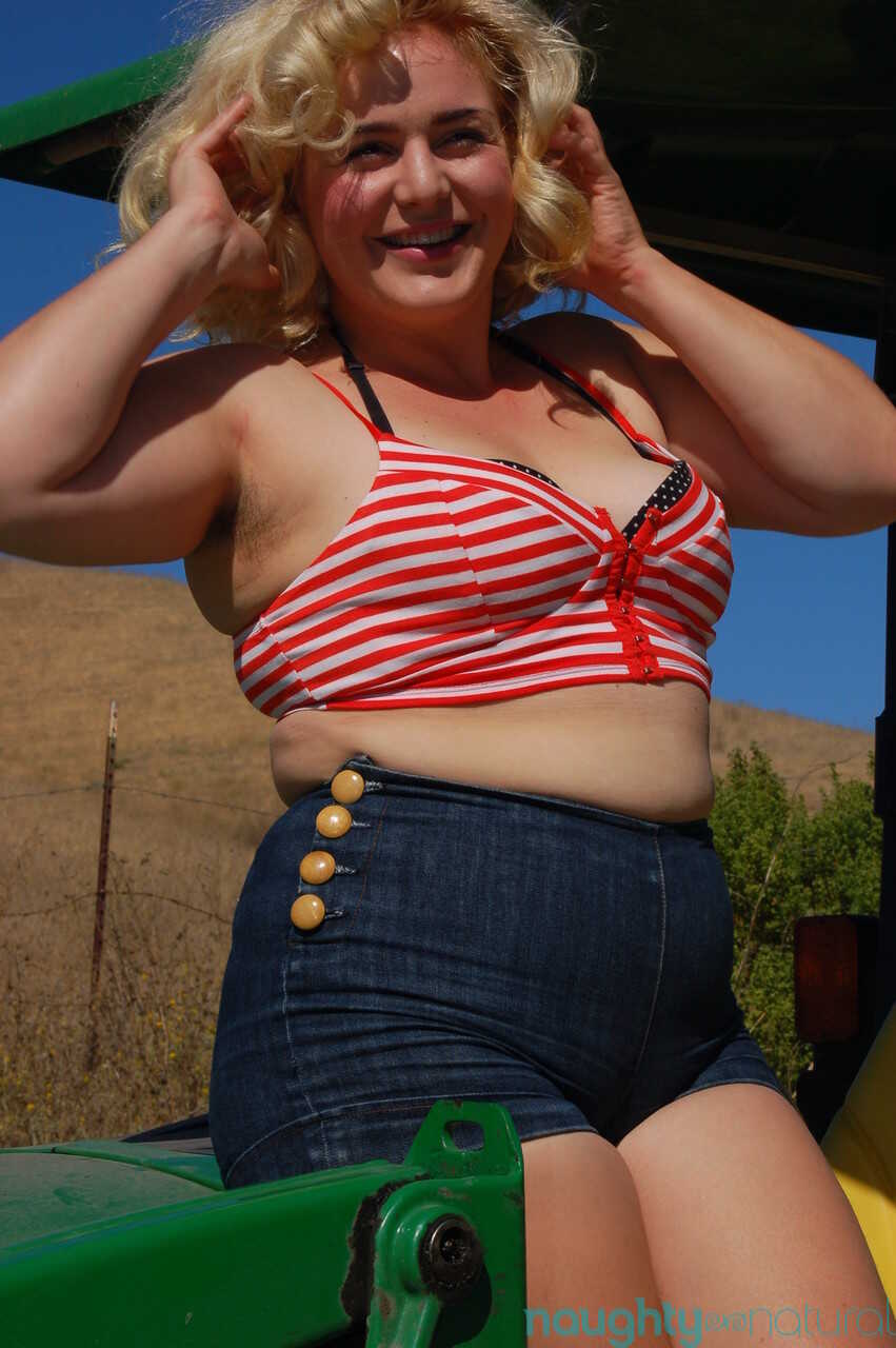 Chubby blonde Poppy Cox strips on a tractor & shows her curves & hairy twat while armpit wiping - Poppy Cox