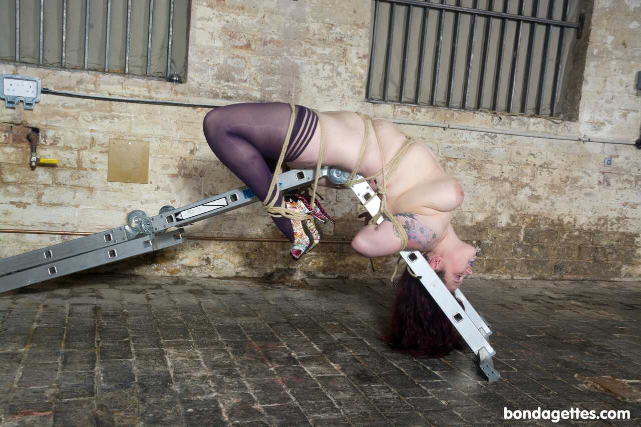 Redheaded Fatty Slavegirl Emma Gets Tied up in a Steel Bondage Construction with Chubby Kinky Fun - Slavegirl Emma