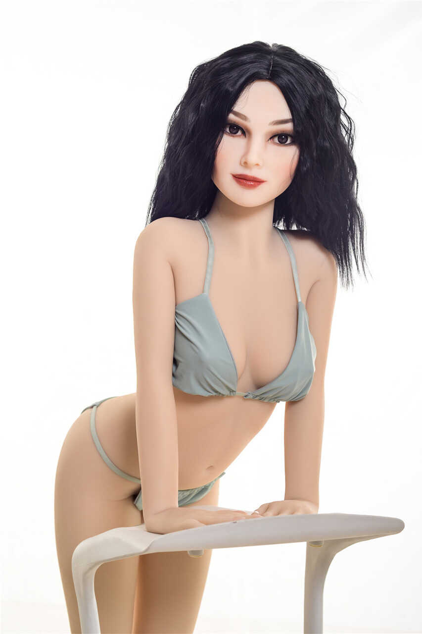 Raven-haired sex doll Coral gets rid of her bikini & poses naked in a chair - 