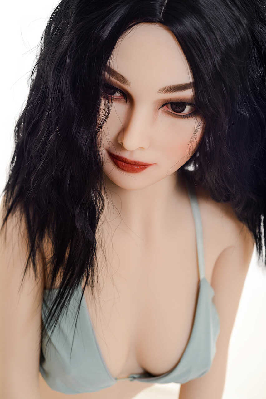 Raven-haired sex doll Coral gets rid of her bikini & poses naked in a chair - 