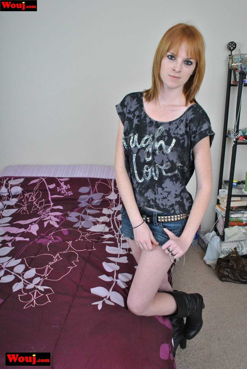 Naughty Redhead Posing with Denim Shorts and Boots: A Sexy Tale of Loneliness and Desire