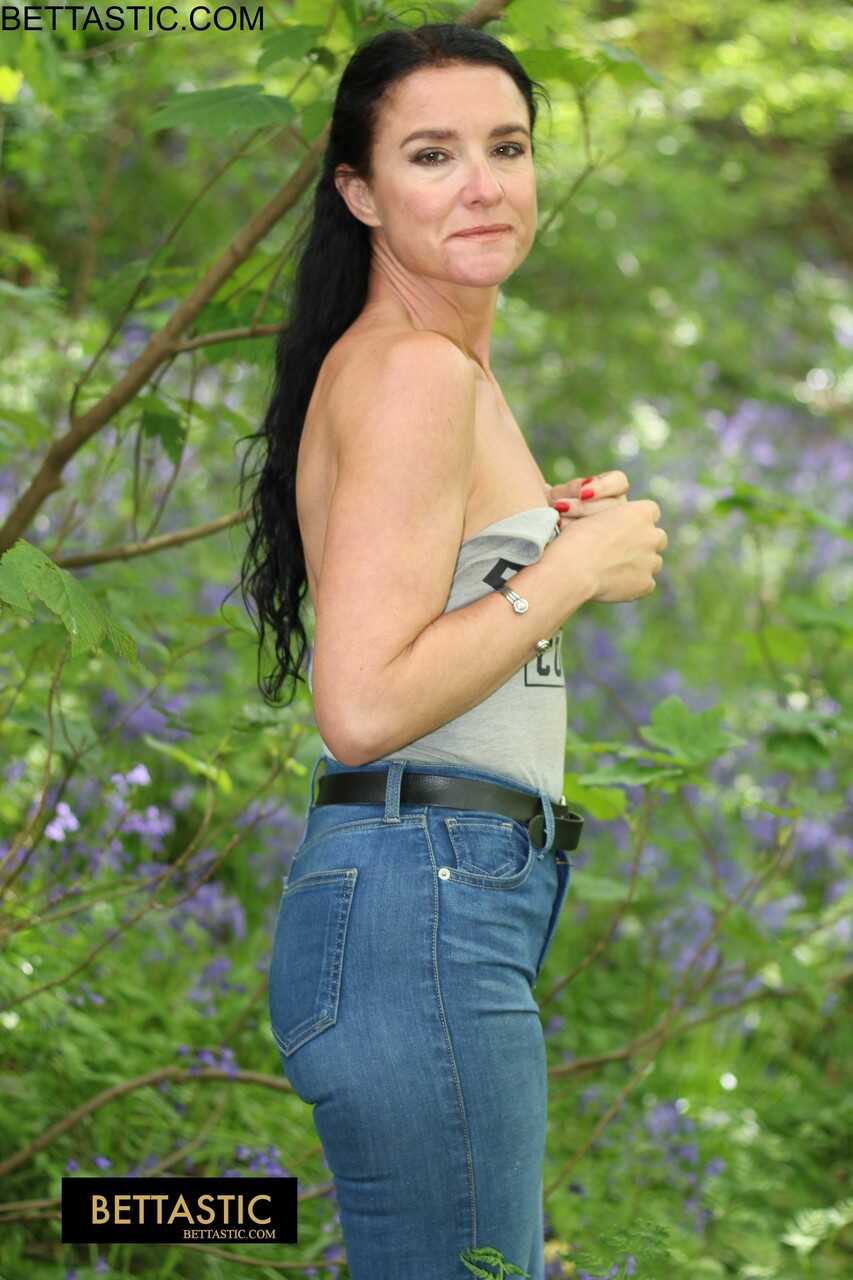 Naughty Nature Girl: Brunette Beauty Posing In Tight Denim Jeans And A Strappy Top Gets Down And Dirty In The Woods