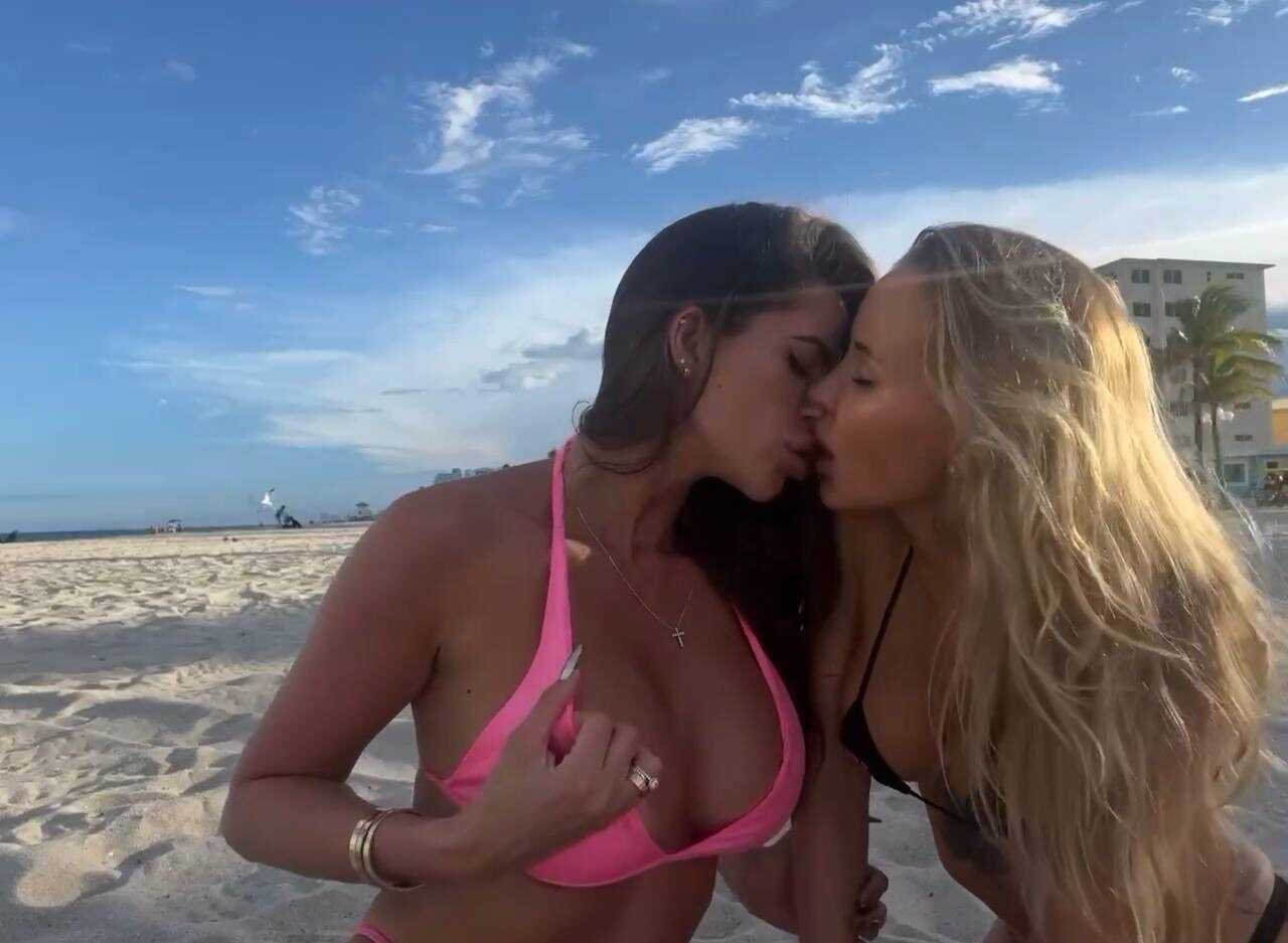 Making out with your sexy girlfriend on the beach while wearing a bikini top and skintight jean shorts - 