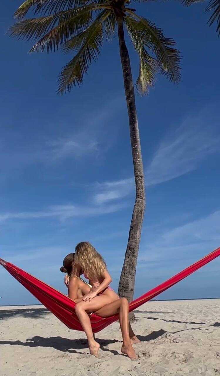 Making out with your sexy girlfriend on the beach while wearing a bikini top and skintight jean shorts - 