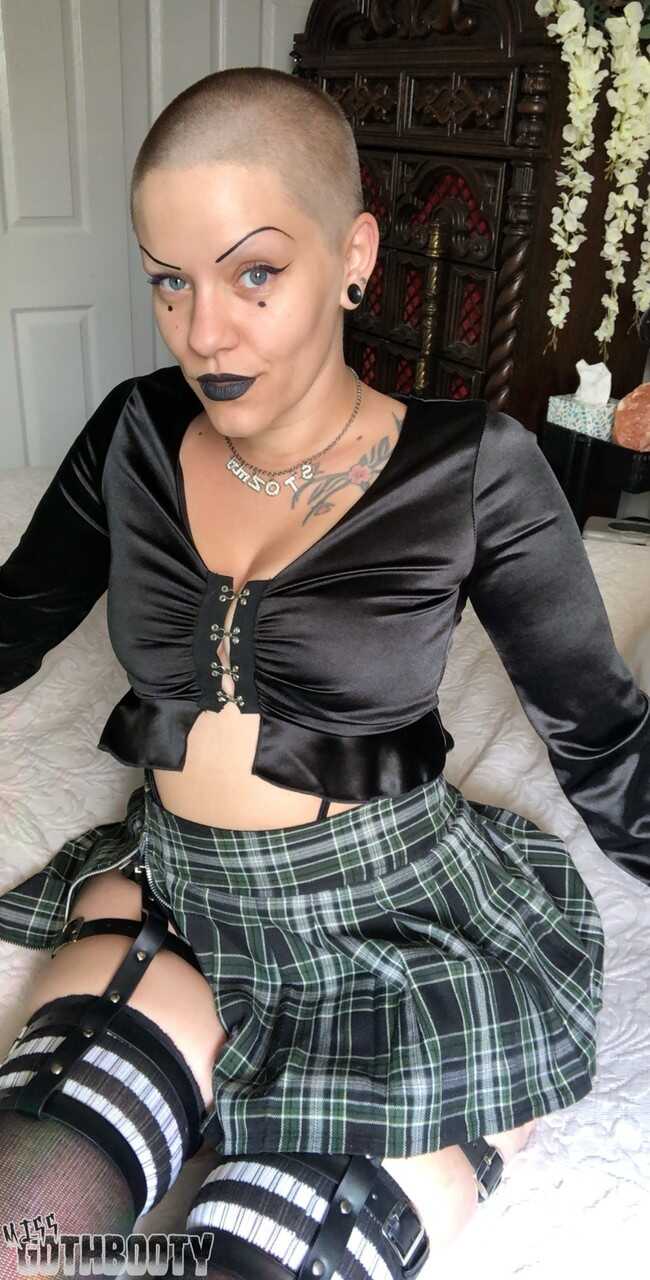 Bald MILF Miss Goth Booty's Thick Thighs Thrill as She Poses in a Plaid Skirt