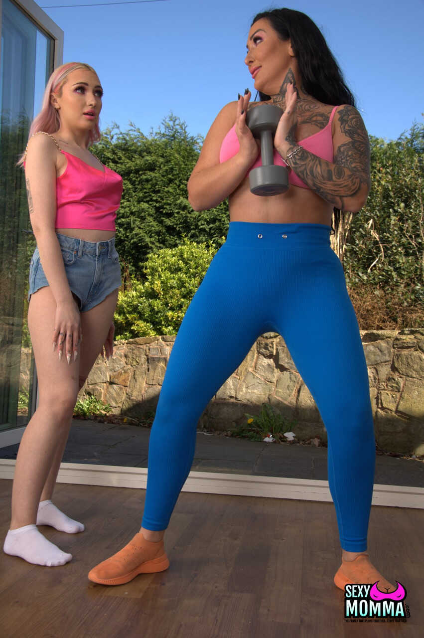 Inked stepmom Ella Bella strips teen Kitty Marie & toys her pussy with her tattooed body and mom feet while wearing he...