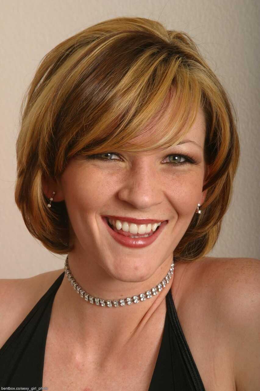 Sexy slender mom Carly posing seductively in a tight corset, panties and stockings - Carly