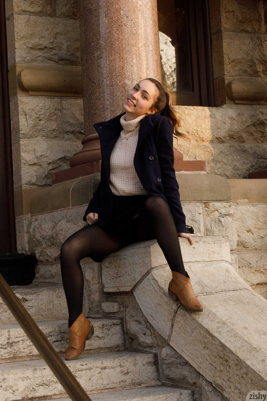 College teen Mallory Christopher flashing her natural tits while giving an upskirt and being innocently nerdy in glasses and pantyhose boots.