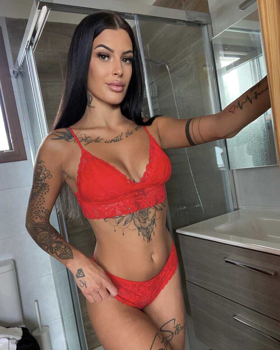 Busty Tattooed Goddess Gets Naughty in Red Lace Lingerie