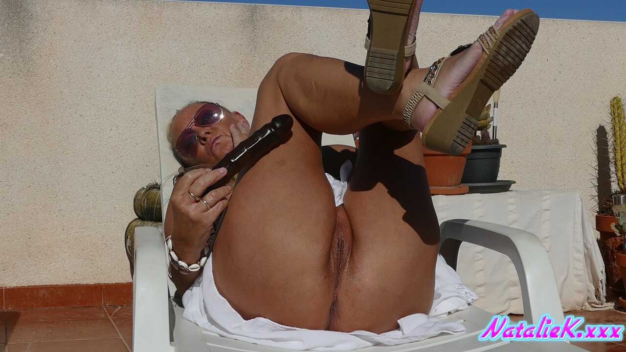 Busty MILF Natalie K rides the dildo hard, leaving no doubt about her sexual prowess! - Natalie K