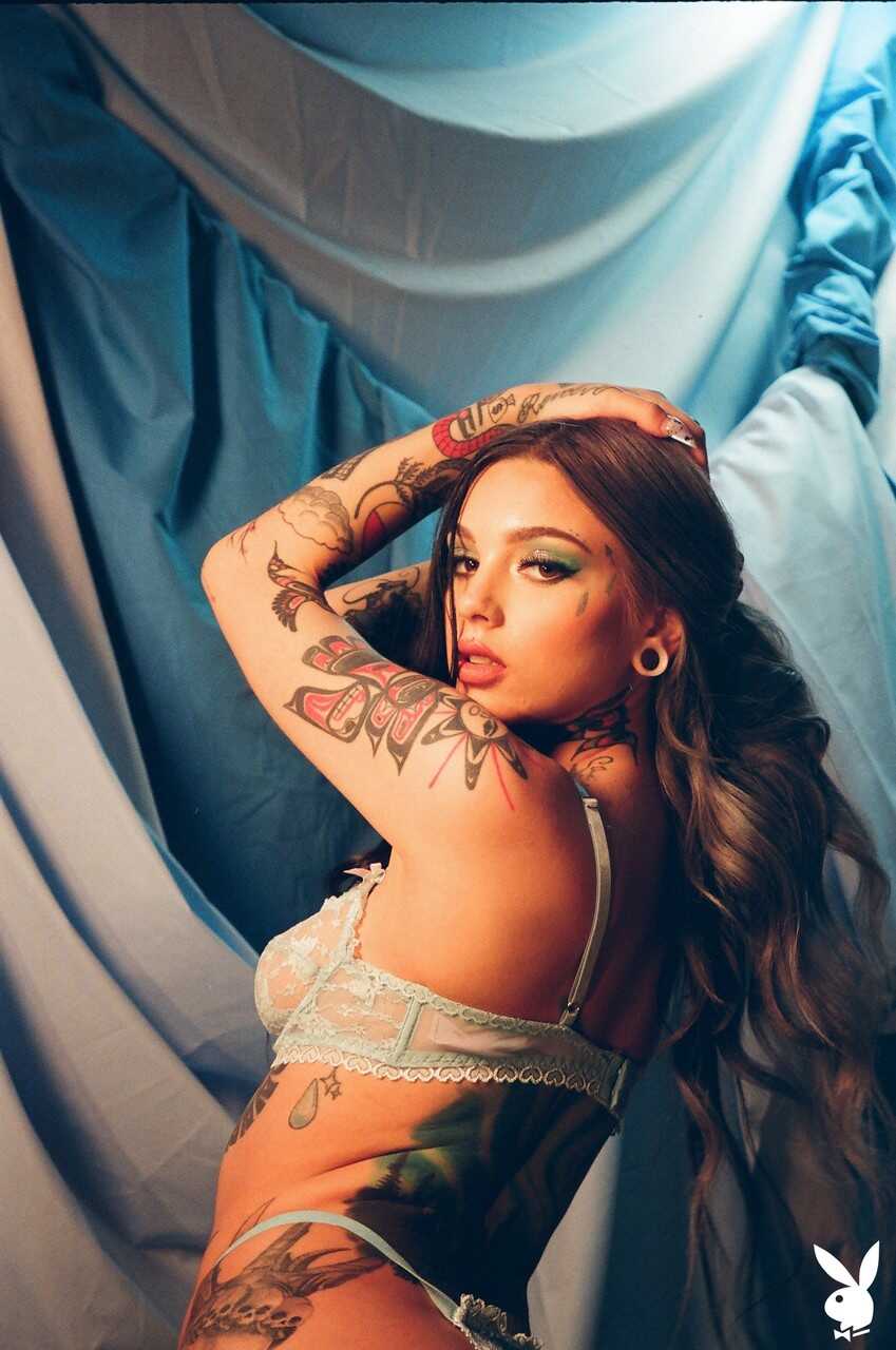 Taylor White's Inked Beauty Unveiled Among Sheets