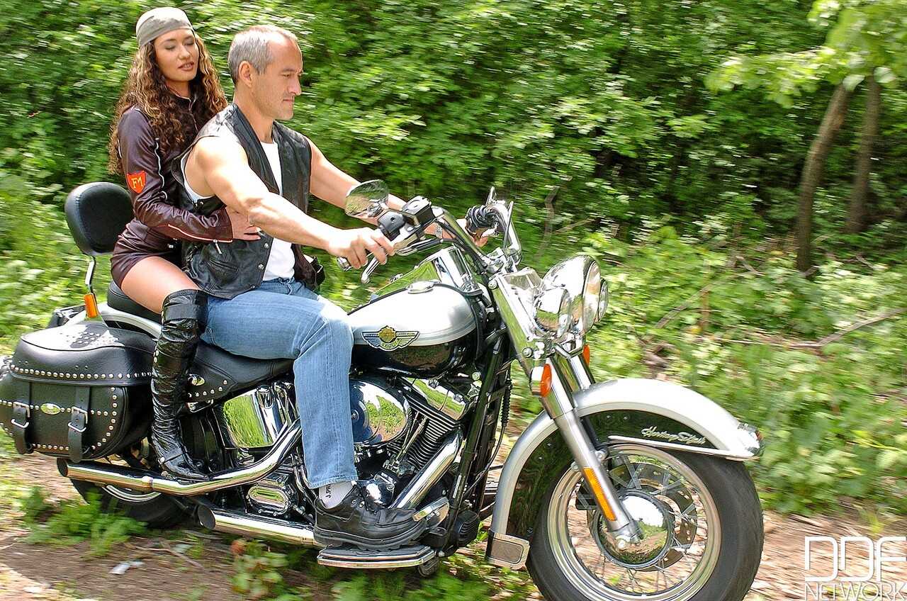 Leather-clad biker babe Vivien L shows off her pierced nipples while enjoying a hard ride with her stiff rod - Vivien L