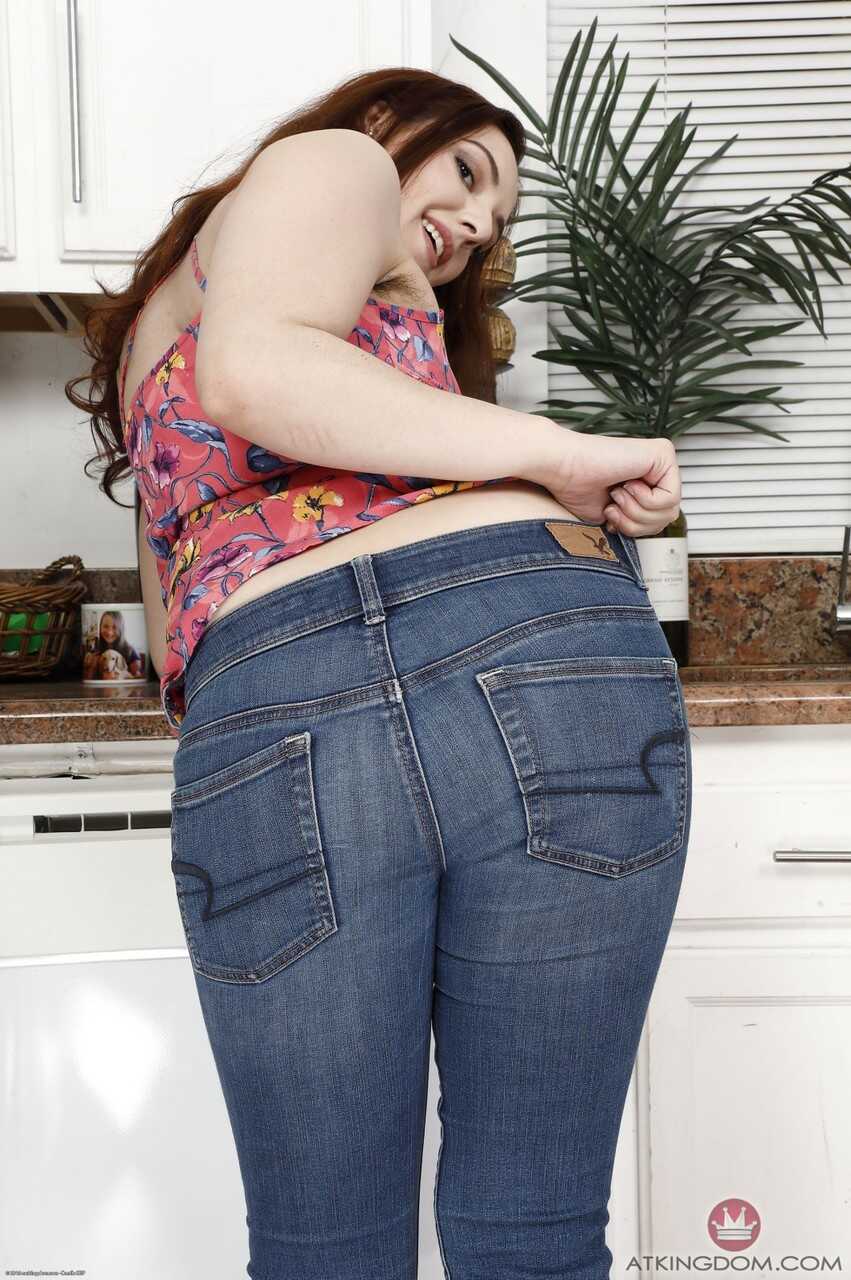 Young girl with a hairy muff Ember Stone takes off her jeans and bends over to show her hairy panties. - Ember Stone