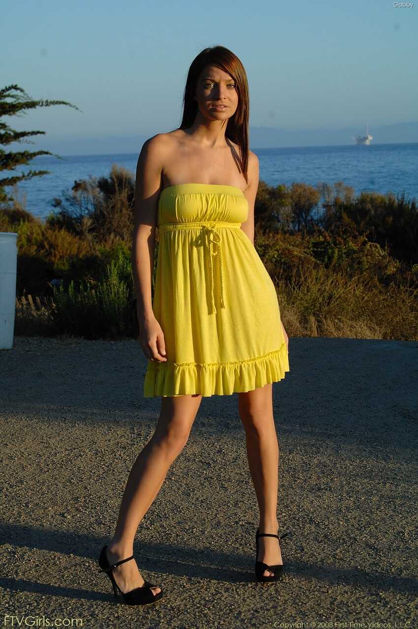 Glamour babe Gabby shows her cuddly tits in a yellow dress & heels outdoors - Gabby